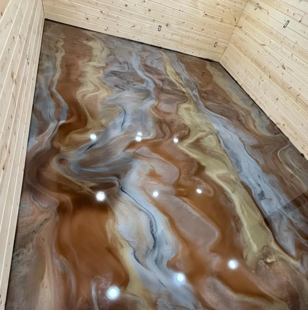 Decorative epoxy floor with brown, tan, and gray swirls.