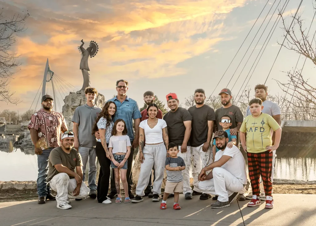 Bolden’s Painting team and families gathered beside the river at sunset.